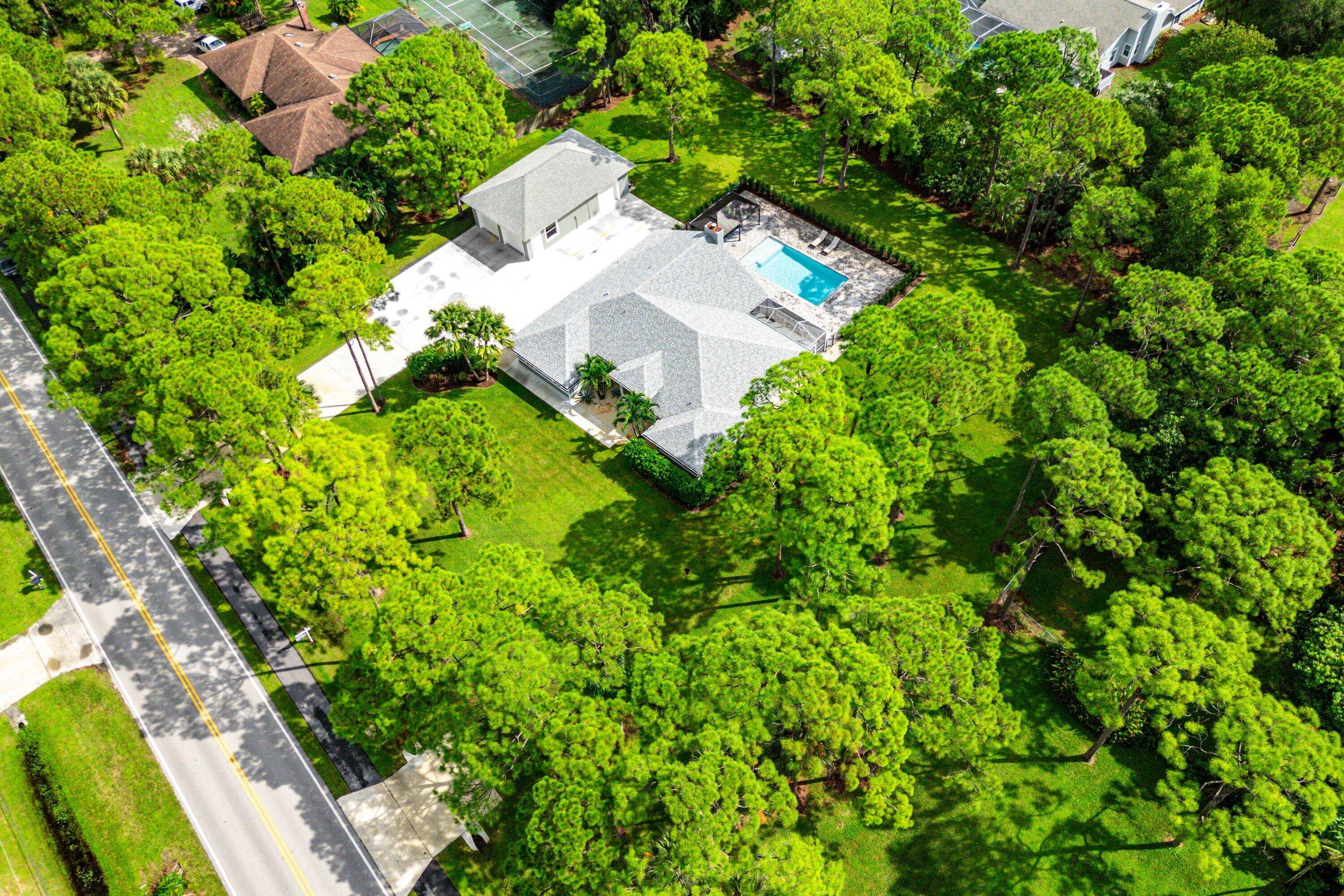 Palm Beach Country Estates Where Elegance Meets Coastal Living Positioned on a paved road in one of Northern Palm Beach County's coveted communities on a 1 acer lot, this completely ...