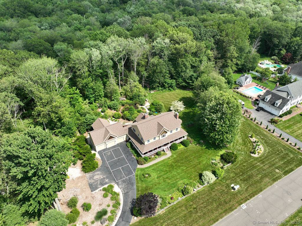 Nestled on 3. 7 private, wooded acres in the heart of Avon, this stunning 5 bedroom, 4.