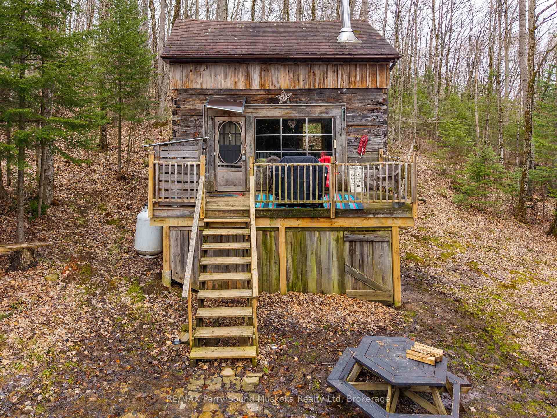Welcome to 479 Doe Lake Road, a truly charming and cozy square timber log cabin nestled on a serene 1.