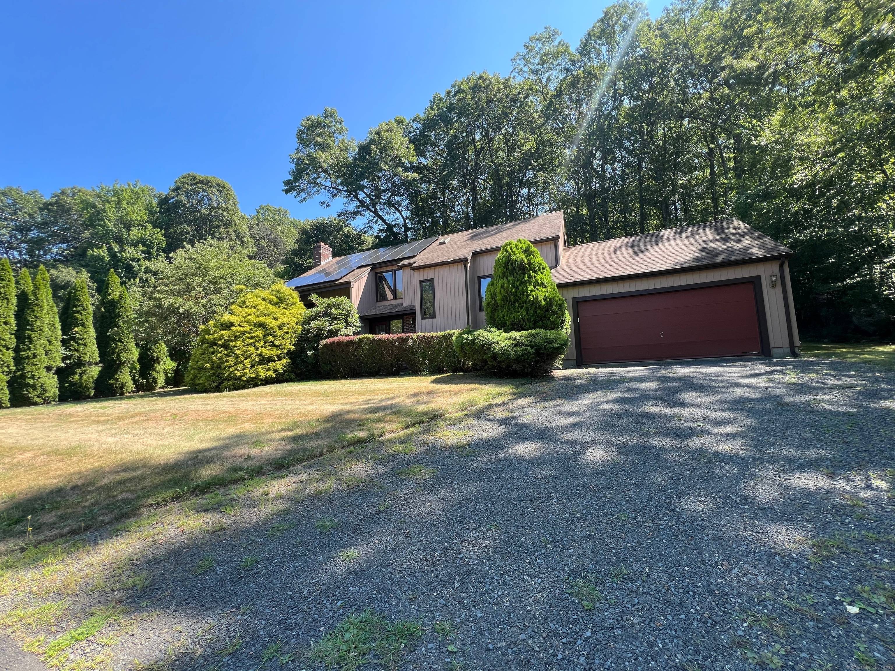 Step into your secluded nature haven, where modern architecture blends with the timeless appeal of Hamden's desirable Mount Carmel neighborhood.