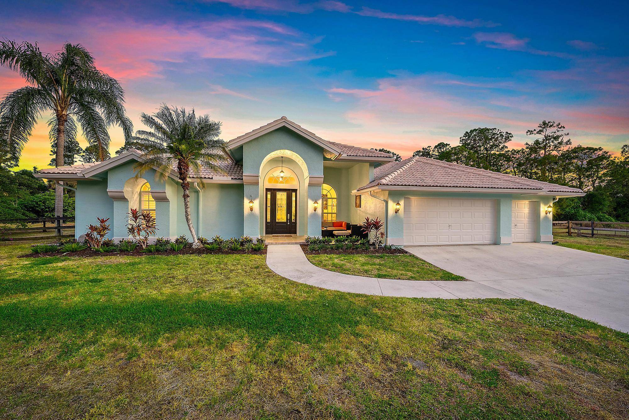 Welcome to your private lakefront retreat in the heart of Jupiter Farms, nestled in the desirable Wildwood Acres community.