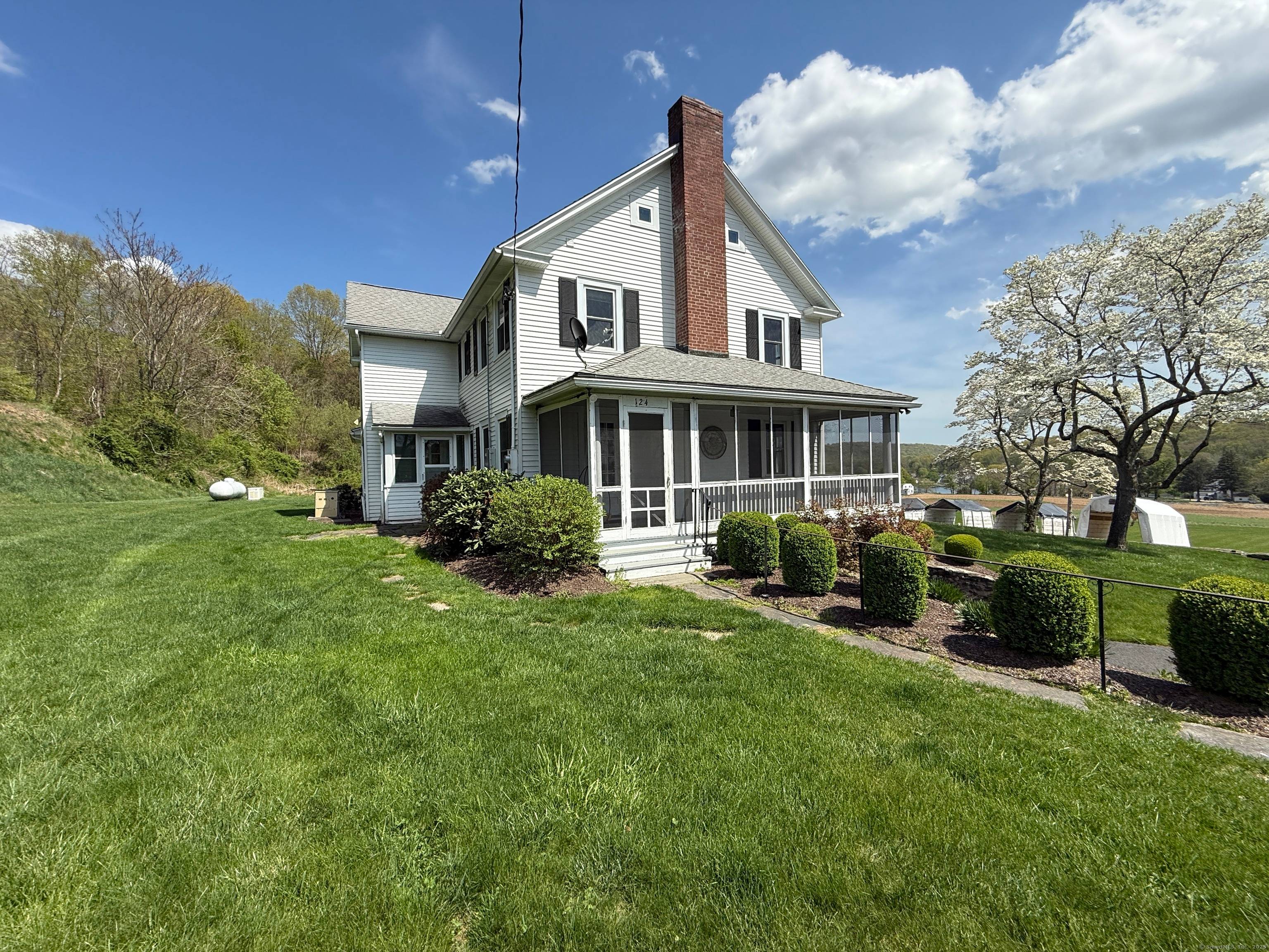 Charming country colonial home with stunning views of expansive farmland.