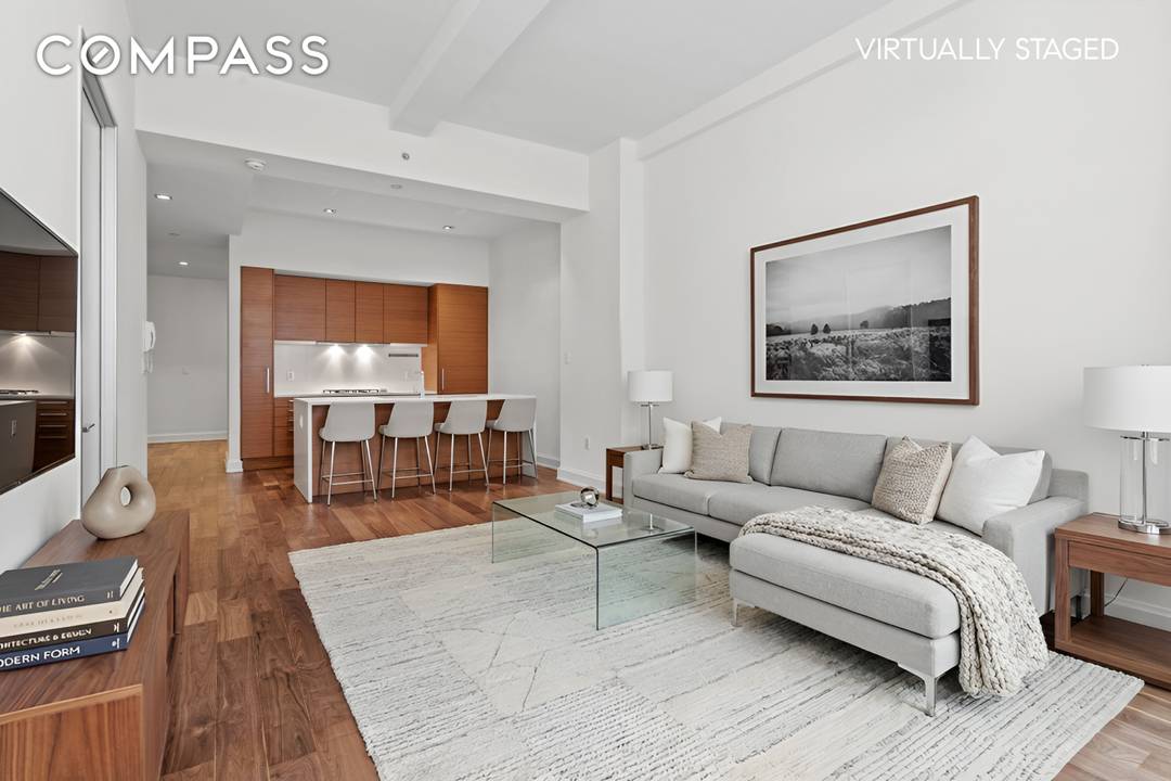 Turnkey loft style residence with oversized windows overlooking West 22nd Street, dramatic 11 foot beamed ceilings, and Italian wide plank oak flooring throughout.
