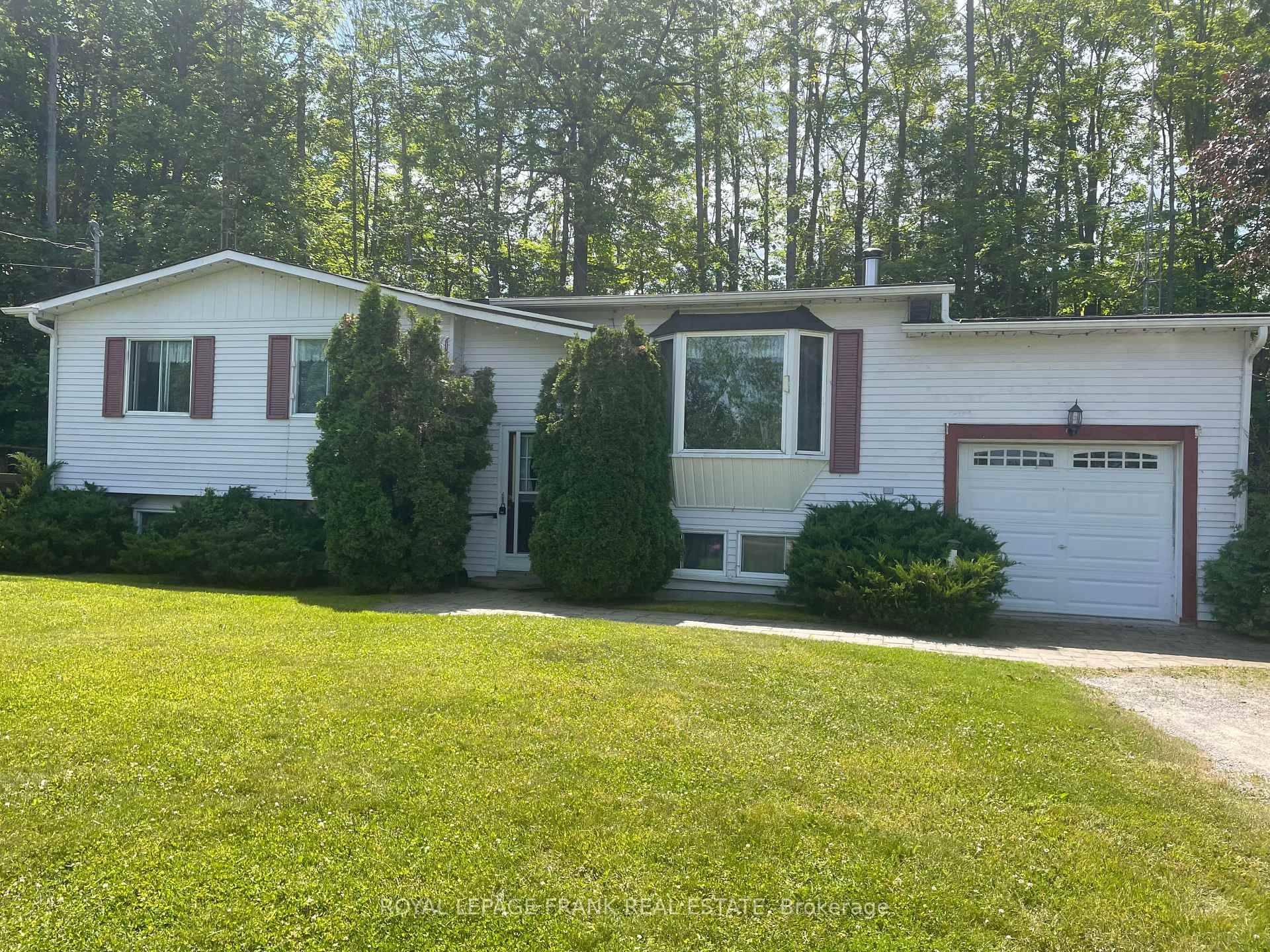 3 2 bedroom raised bungalow with attached single car garage, located on just over one acre.