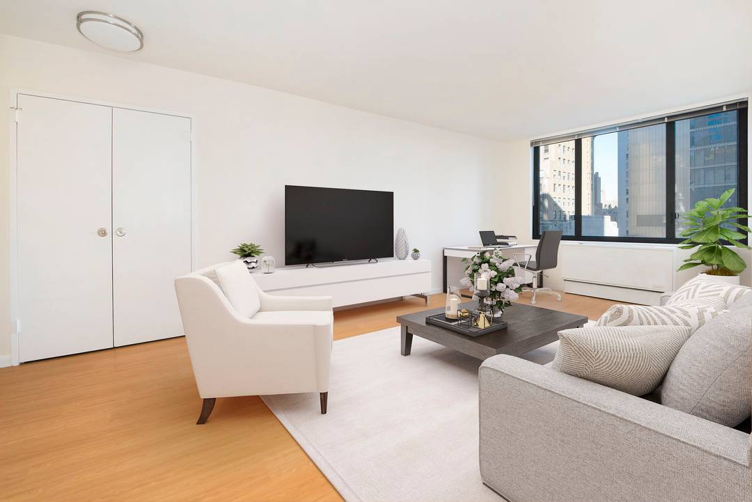 Quiet one bedroom with wall of windows in living room and bedroom, wood floors throughout, a fully equipped kitchen, and a windowed bathroom.