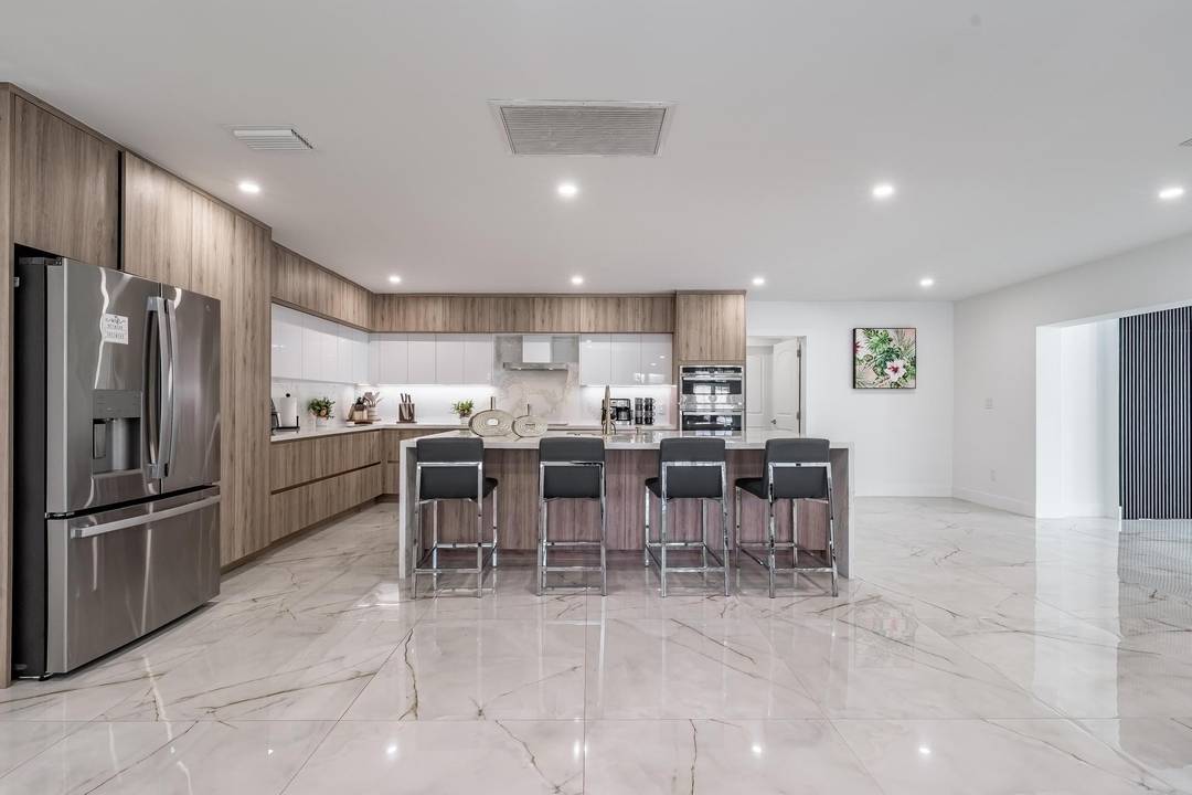 Experience uncompromising modern luxury in this fully reimagined residence, anchored by a show stopping chef s kitchen w waterfall quartz islands, custom cabinetry, expansive counters, amp ; double wall ovens ...