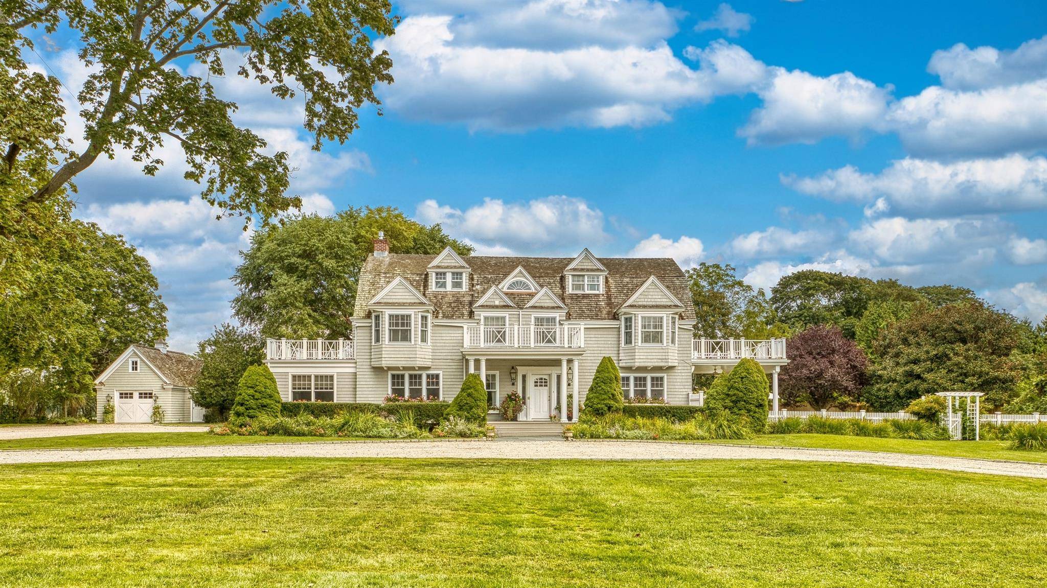 An inviting and impressive white stone drive welcomes you to this Magnificent, Nantucket Style Beach Cottage in the heart of the Village of Westhampton Beach.
