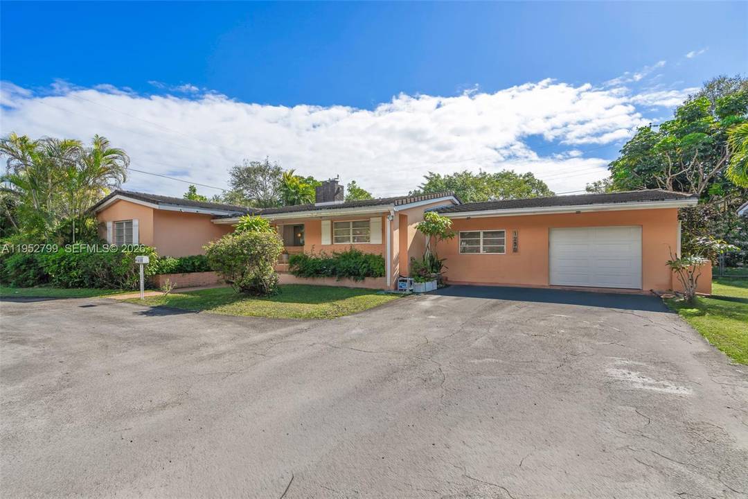 Welcome to 1230 Bird Road, a bright and inviting residence designed for effortless Miami living.
