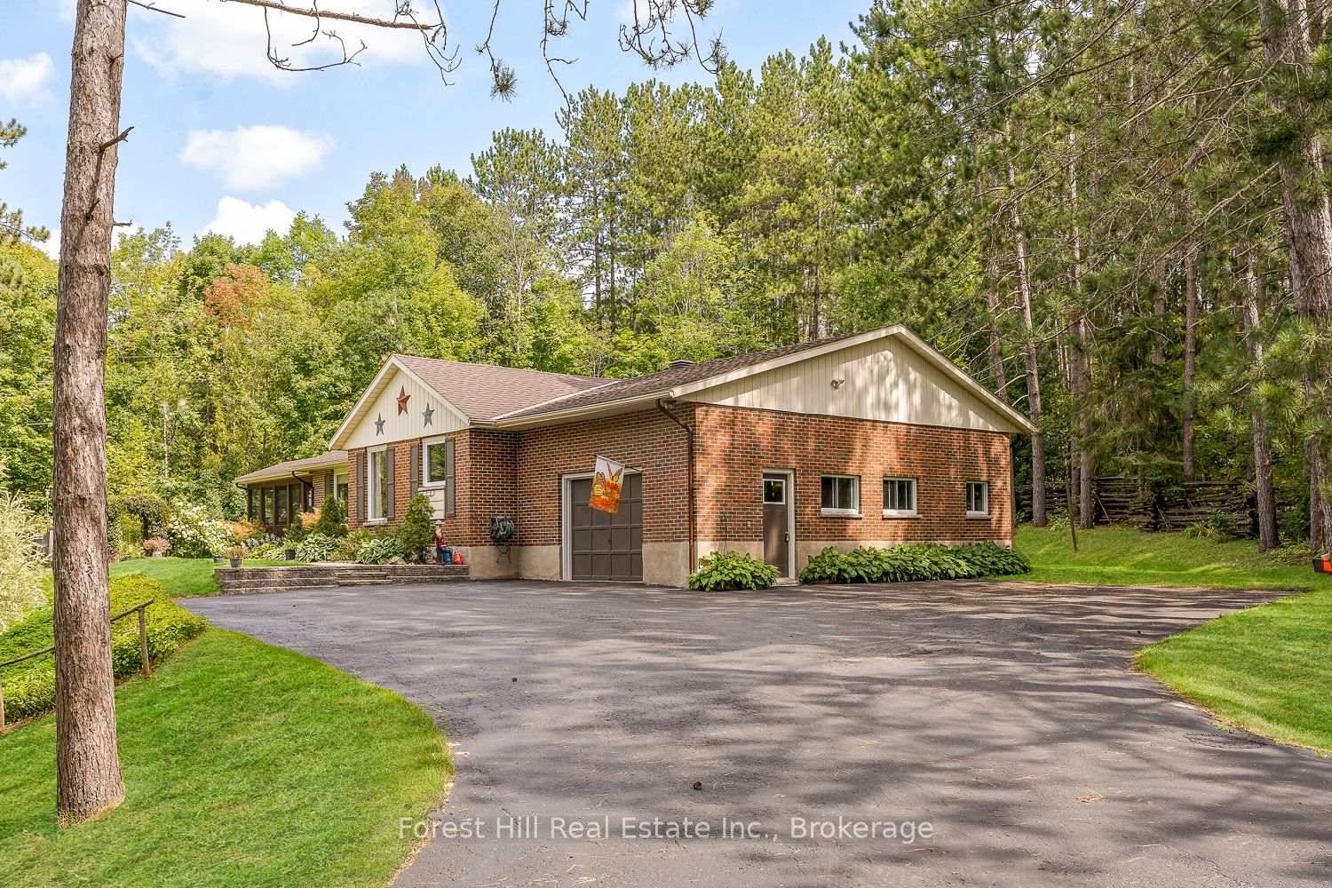 Manicured gardens, towering trees, and a backyard oasis set the stage for this beautifully maintained bungalow on nearly an acre of land.
