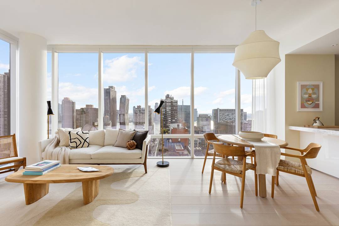 Luxury corner home with 10' floor to ceiling windows and expansive views of the River, Manhattan skyline and Long Island City.
