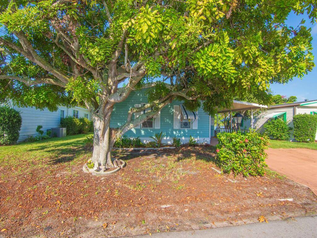 ENJOY THE VIEW from your lakefront back patio in the beautiful 55 community of Pinelake Gardens in south Stuart !