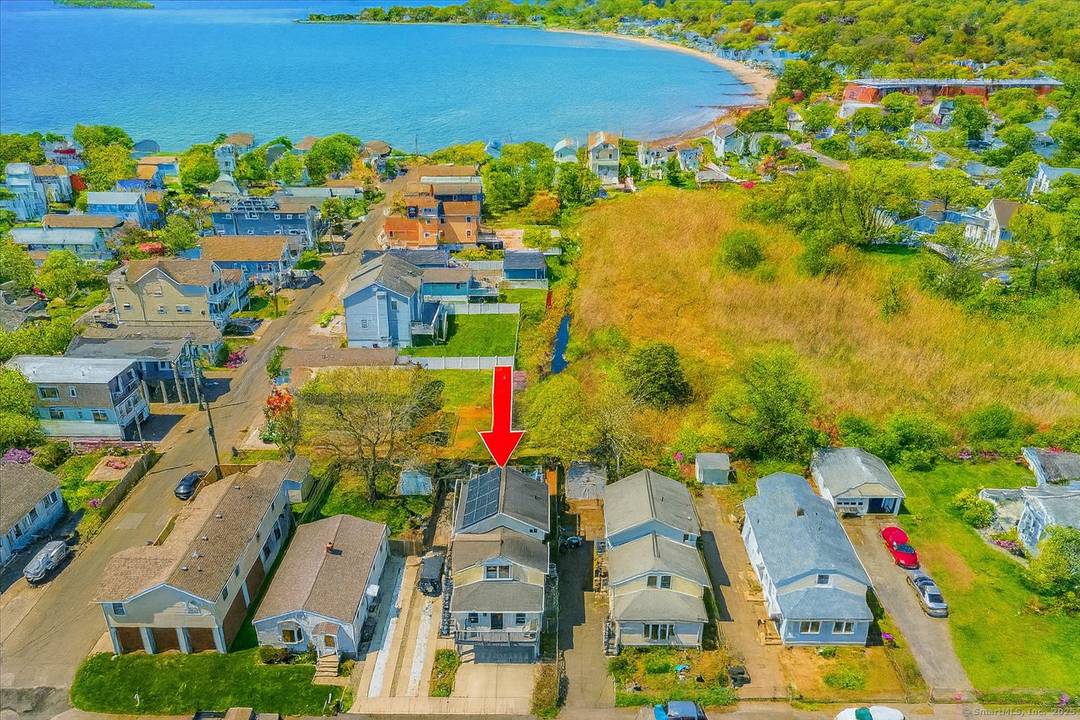 A home that redefines coastal living in Milford's coveted Point Beach enclave.