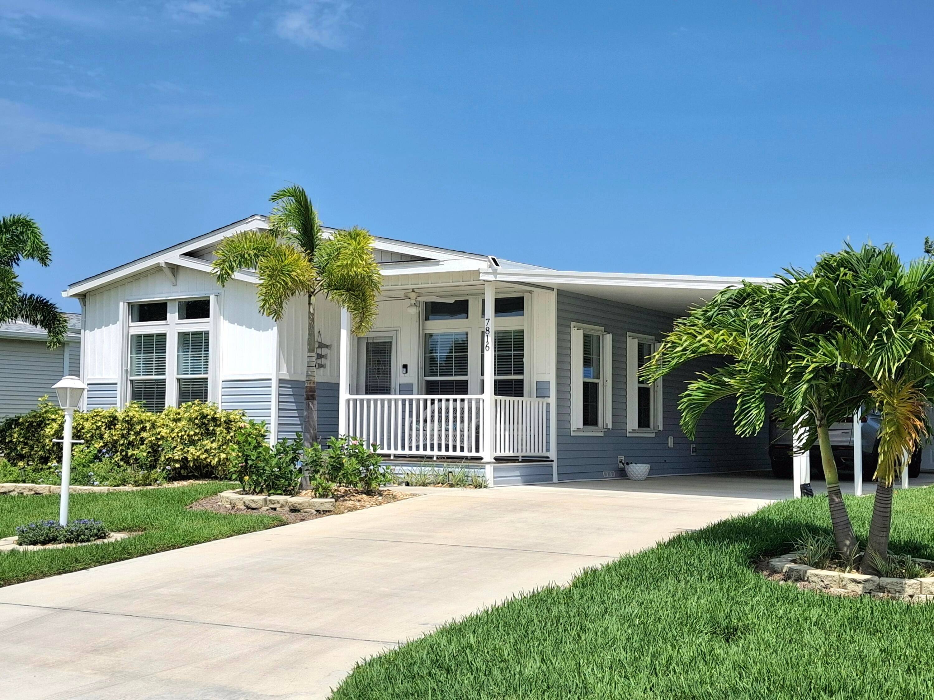 Fabulous MOSTLY FURNISHED 2022 home overlooking the golf course with 2 bedrooms, a den, AND a golf cart garage with a remote control door.