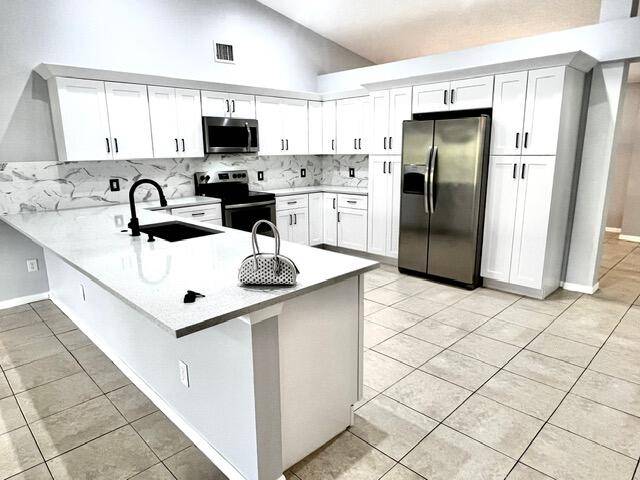 CITY WATER and REMODELLED 3 bedroom 2 bathrooms home with a separate den office, screened in porch, separate air conditioned laundry room and a two car garage.