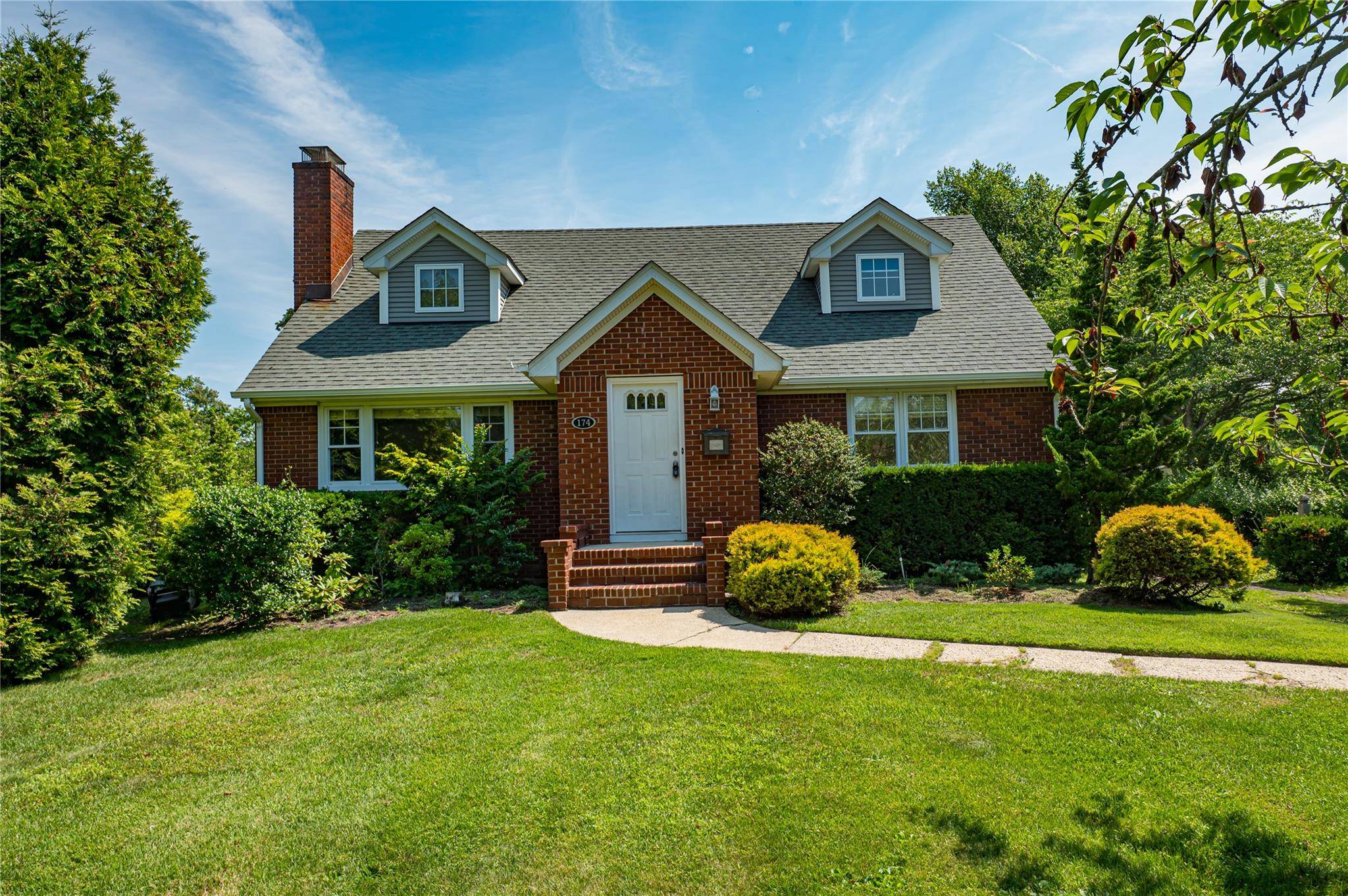 On one of the finest and most prestigious streets in all of Brightwaters and on a generous.
