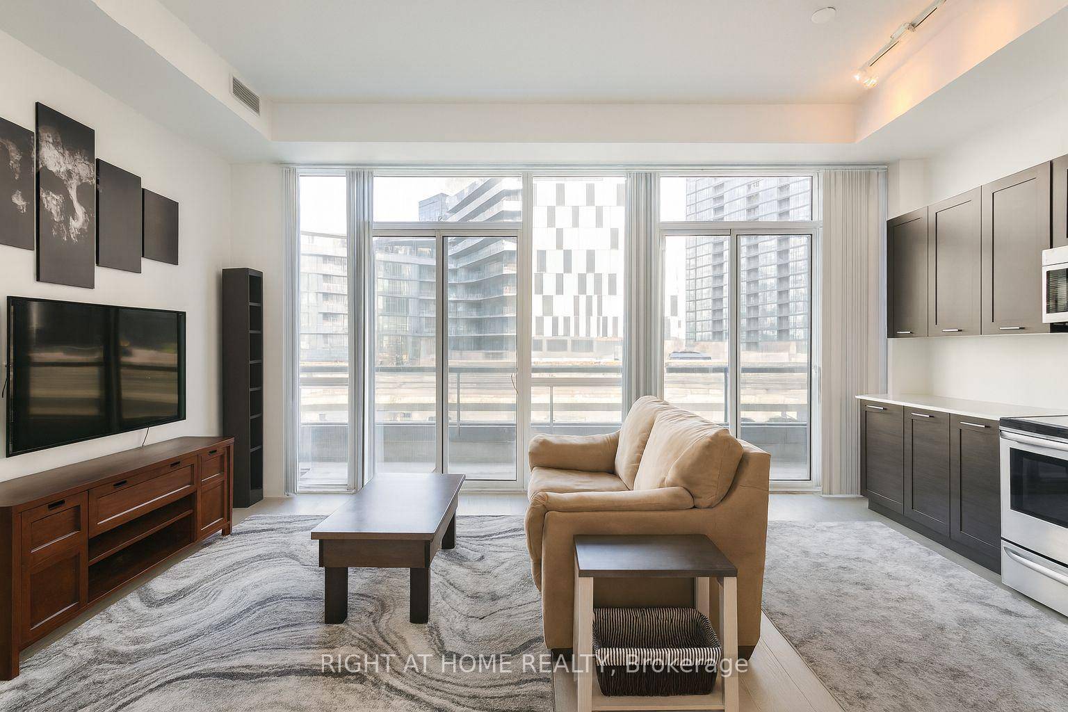 Modern 1 Bedroom Den condo with soaring 11 ft ceilings, 1 full bath, and a spacious walk out balcony with 2 sliding doors in a prime downtown location steps to ...