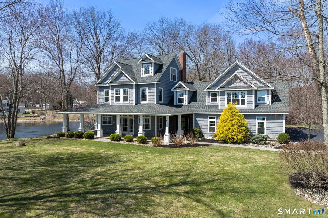 Set on a rare 7 private acres at the point of Coventry Lake, this extraordinary waterfront retreat captures the feeling buyers dream about but almost never find.
