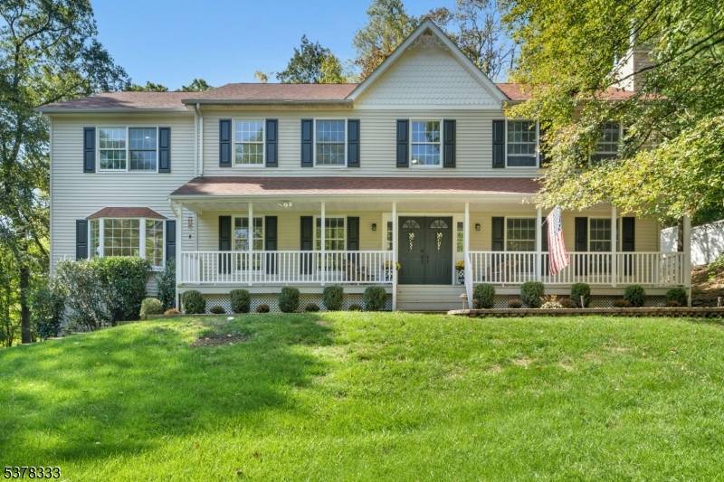 Perched on a verdant lot, this meticulously maintained 4 bedroom, 2.
