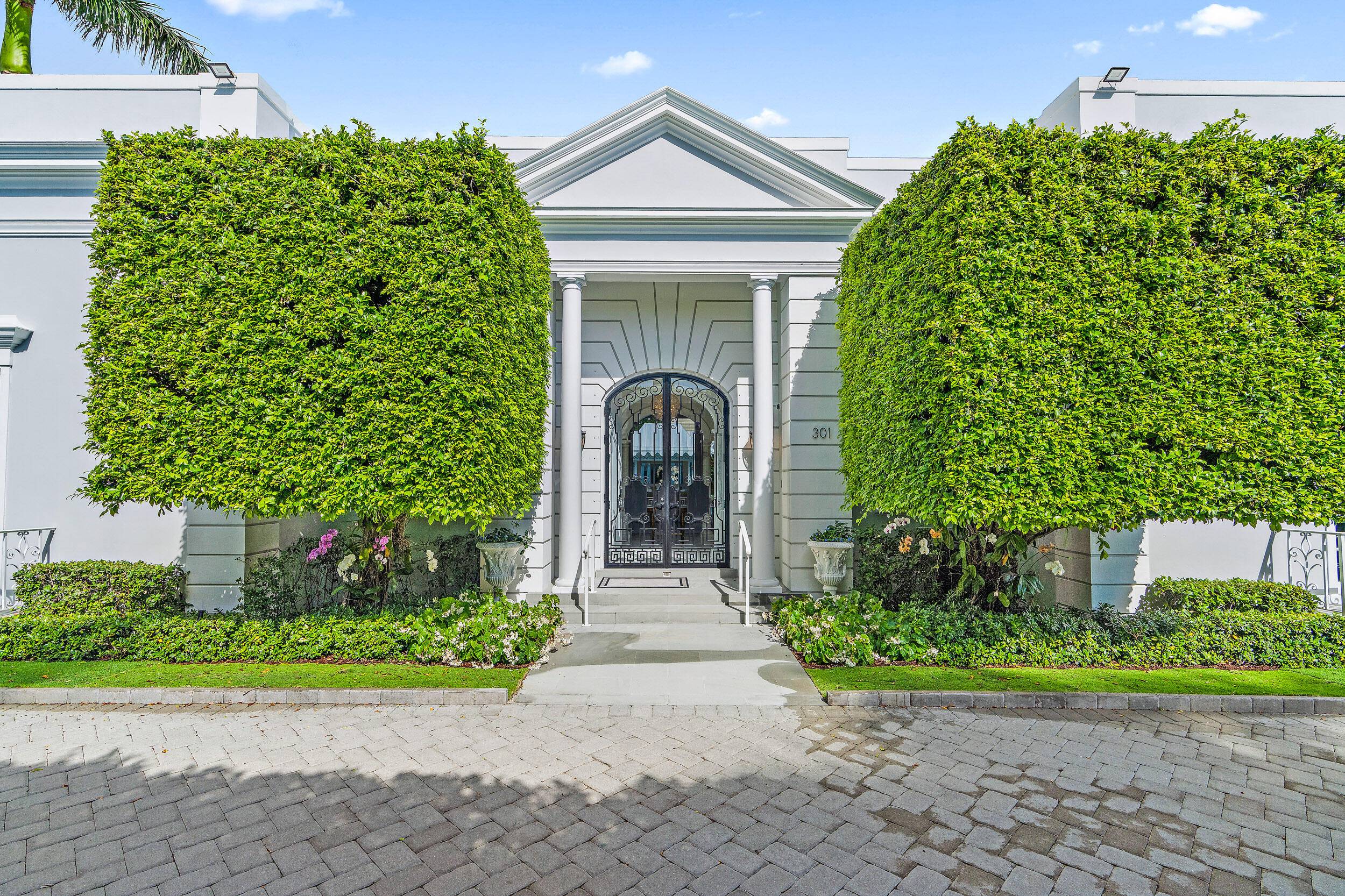 Regally elevated on over half acre this very proper Palm Beach residence showcases quintessential Palladian architecture set within beautifully landscaped pool gardens.