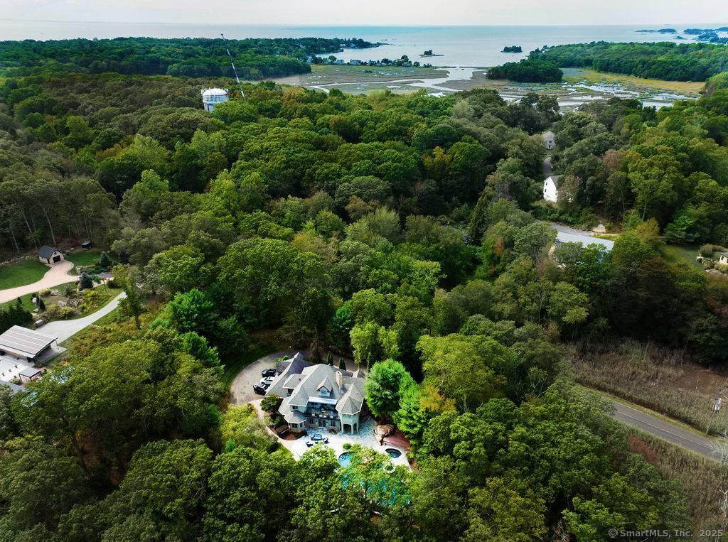 Resort like gated estate perched high above Sachem Head Road overlooking a saltwater tidal marsh nestled on 2.