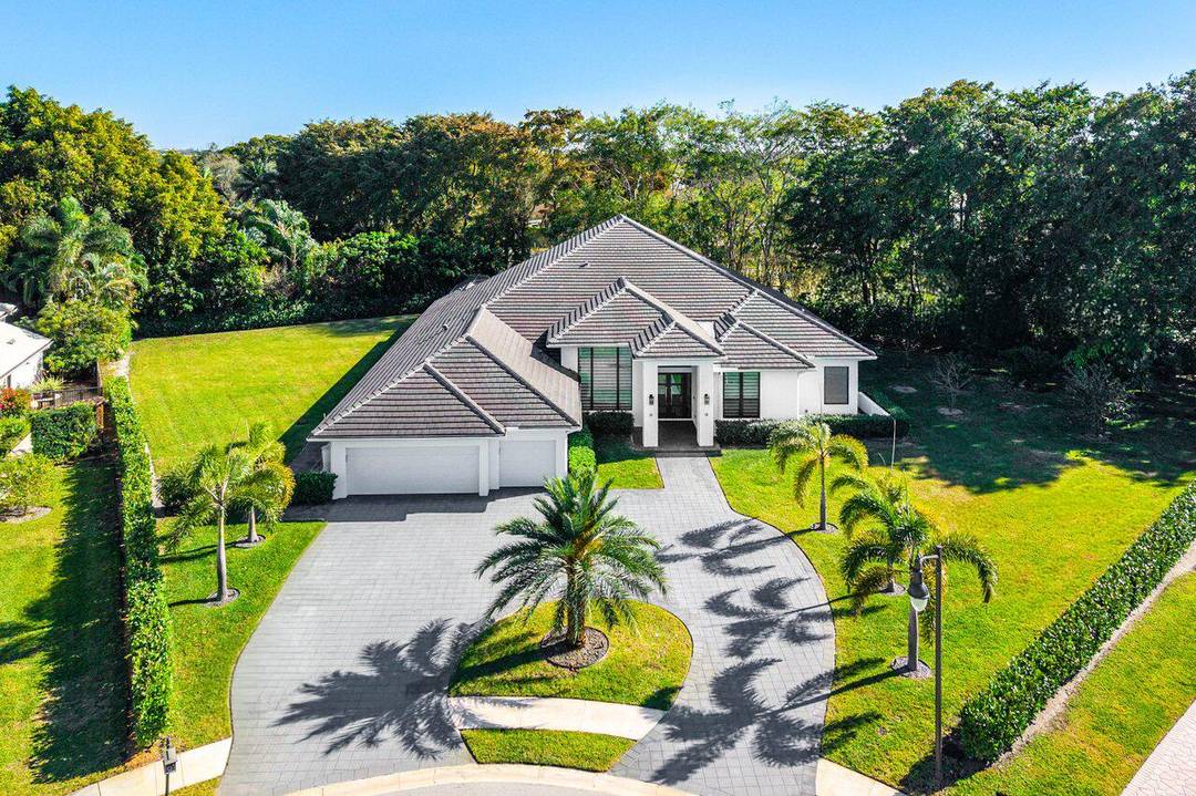 Welcome to an extraordinary, fully reimagined contemporary estate tucked away at the end of a quiet cul de sac in prestigious Bocaire Country Club.