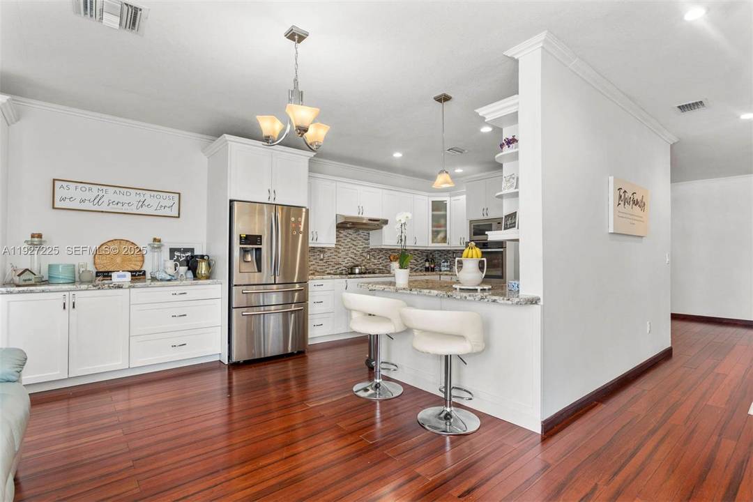 This inviting 4 bedroom, 2 bath residence tucked inside a serene gated community with low HOA fees and private lake access, where warm, natural Cherrywood floors welcome you in, sets ...