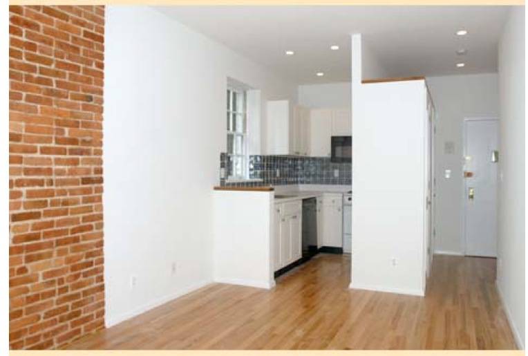 Lovely two-bedroom with exposed brick walls and hardwood floors.