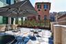 Stunning shared terrace furnished with umbrellas and tables 