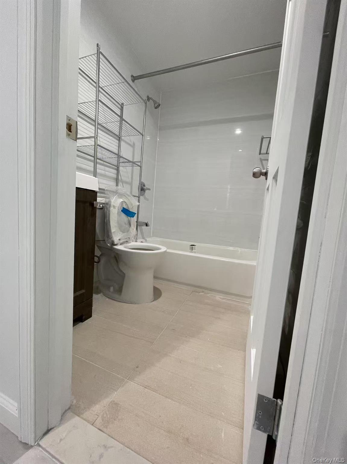 Full bathroom featuring toilet, vanity, and bathing tub / shower combination