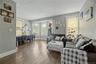 Hardwood flooring throughout, multiple windows, and crown molding