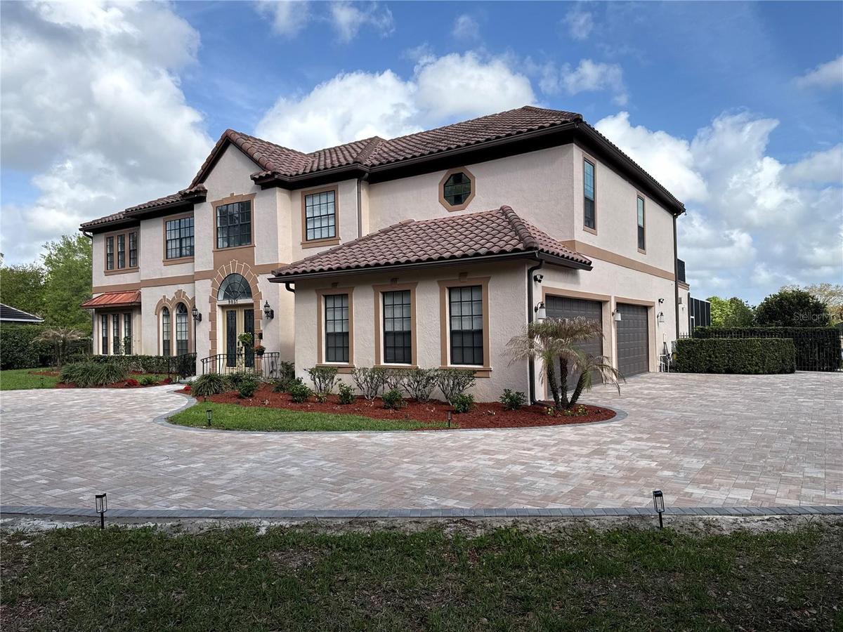 Welcome Home! Gorgeous mediterranean style estate set on almost 3/4 acre. Custom circular paver driveway with fountain.