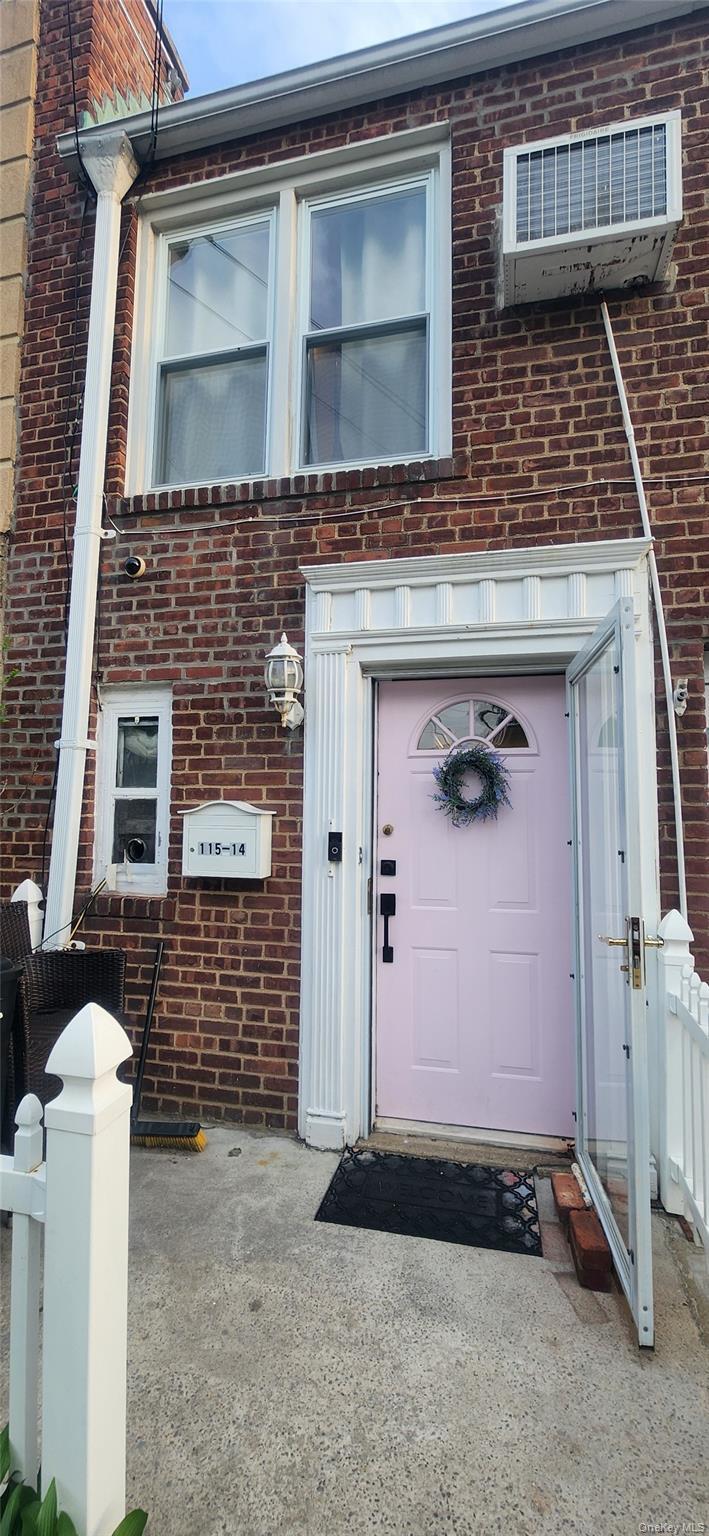 Doorway to property with brick siding