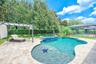 Stunning pool featuring a sunshelf with a umbrella holder and bubbler as well as an oversized hot tub/spa.