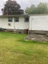 Back of house featuring a yard and a chimney