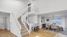 Staircase with a high ceiling, wood finished floors, and baseboards