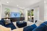 Family room with recessed lighting, built-in Signature cabinets and sliders to lanai