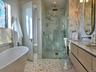 Bathroom with a shower stall, a freestanding tub, vanity, and toilet