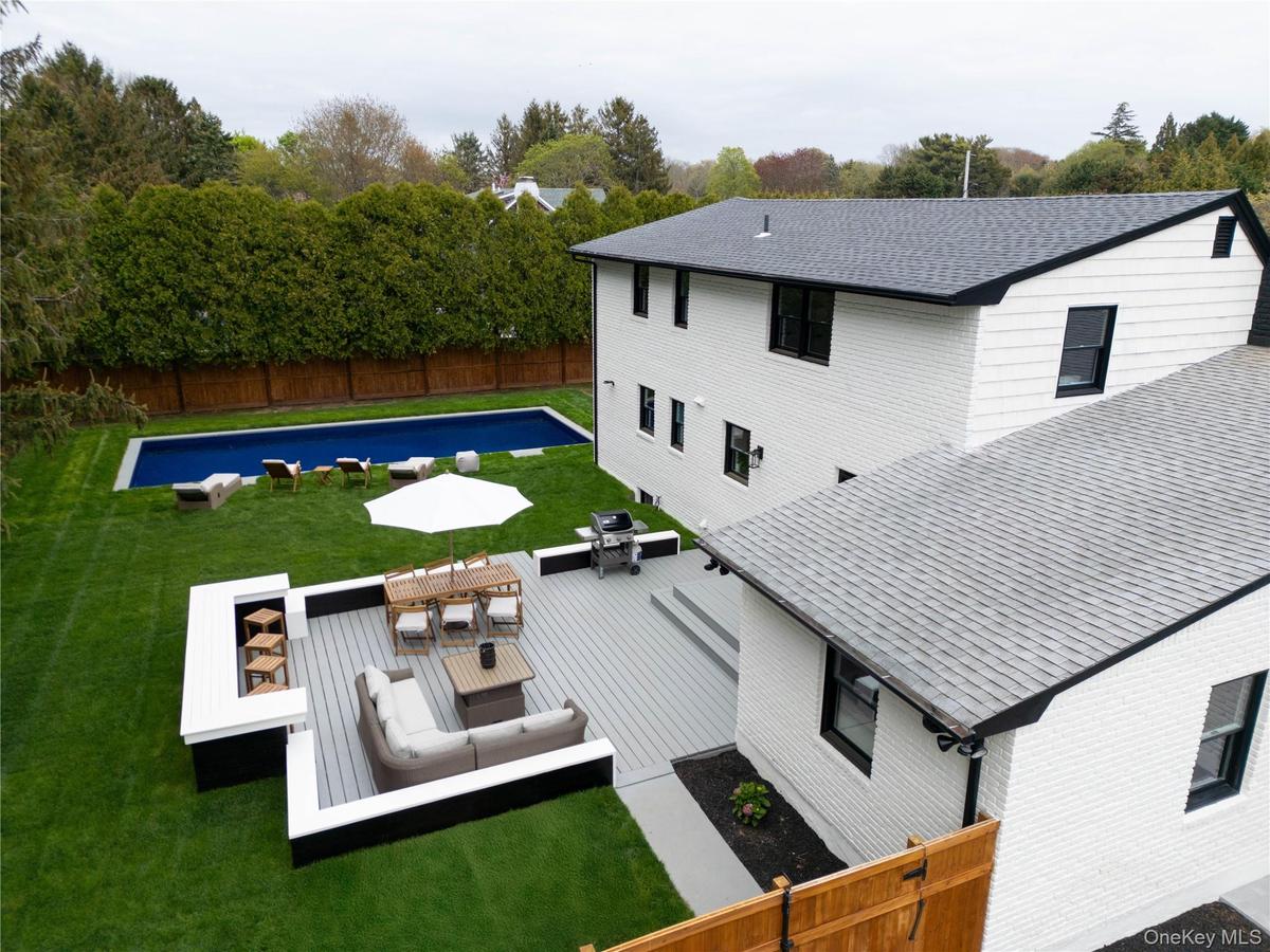 Back of property featuring a fenced backyard, a patio, outdoor dining space, outdoor lounge area, and view of scattered trees