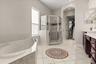 Primary bathroom with soaking tub, shower, double vanities and private water closet