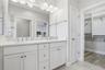 Primary bathroom with double sink and extra large walk in closet