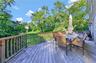 Wooden deck featuring grilling area, a yard, and outdoor dining space