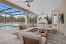 Oversized covered lanai designed for year-round outdoor living, dining and entertaining with peaceful water front views.
