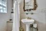 Guest cottage full bathroom featuring walk in shower, pedestal sink