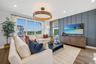 Spacious living area featuring large windows with wood-finish flooring.