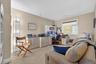 Home office with light colored carpet and baseboards