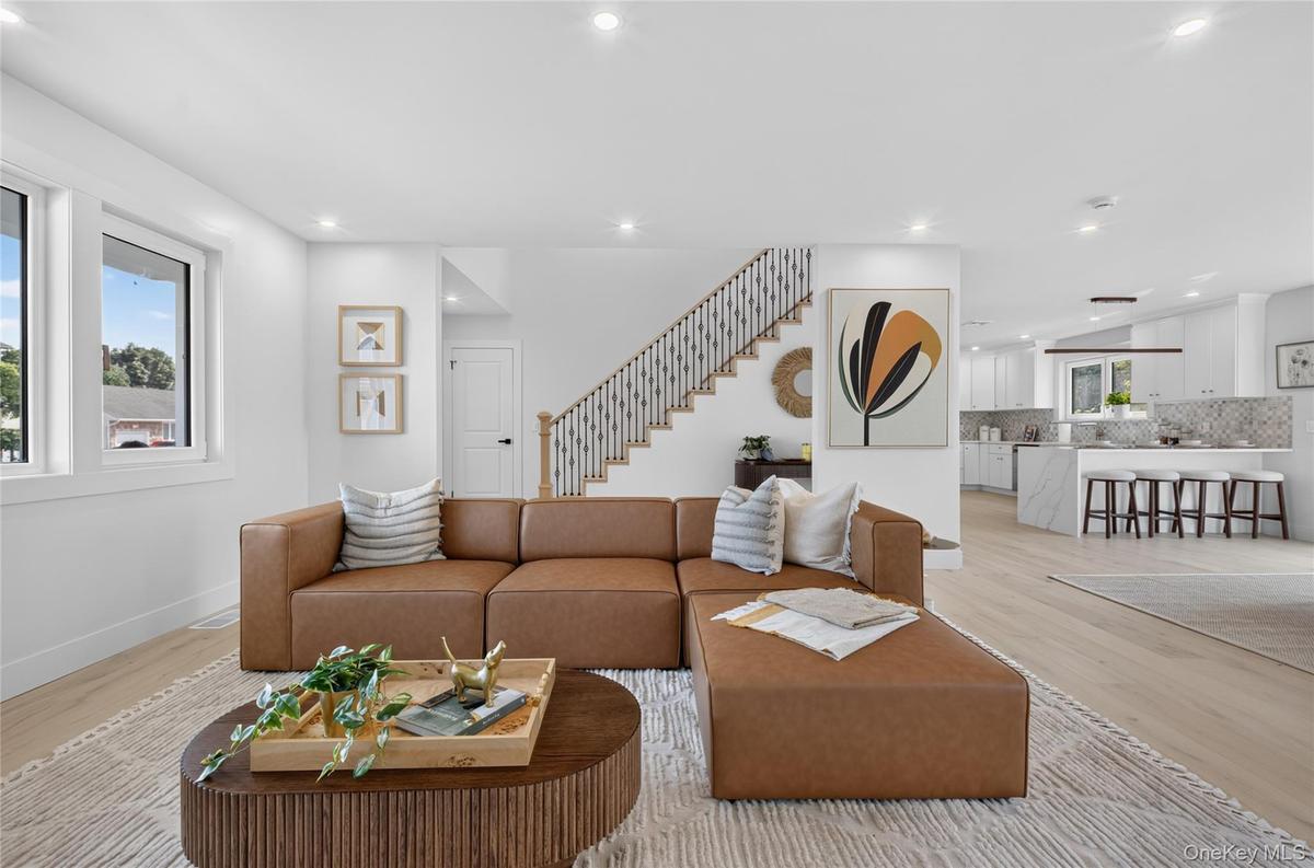 Open concept living area featuring light wood-finish flooring