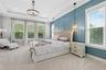 The primary bedroom is exquisite with tray ceilings and wall molding.