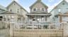 View of front of house with covered porch and a fenced front yard