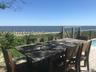 View of patio / terrace featuring outdoor dining space, an outdoor pool, and a deck with water view