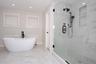 Full bathroom featuring a soaking tub, light marble finish flooring, a marble finish shower, and recessed lighting